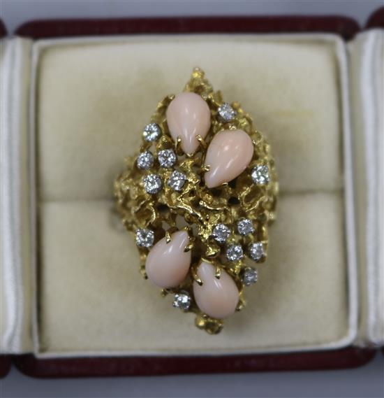 A 1970s textured yellow metal, coral and diamond rustic form dress ring, size M.
